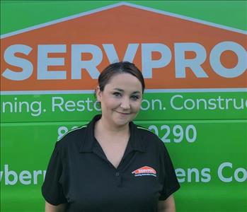 Katie Young - Production Technician standing in front of a green SERVPRO Van