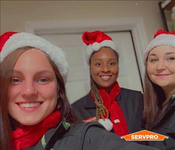 SERVPRO Clean team bringing some Christmas cheer adding Santa hats to their uniform. 
