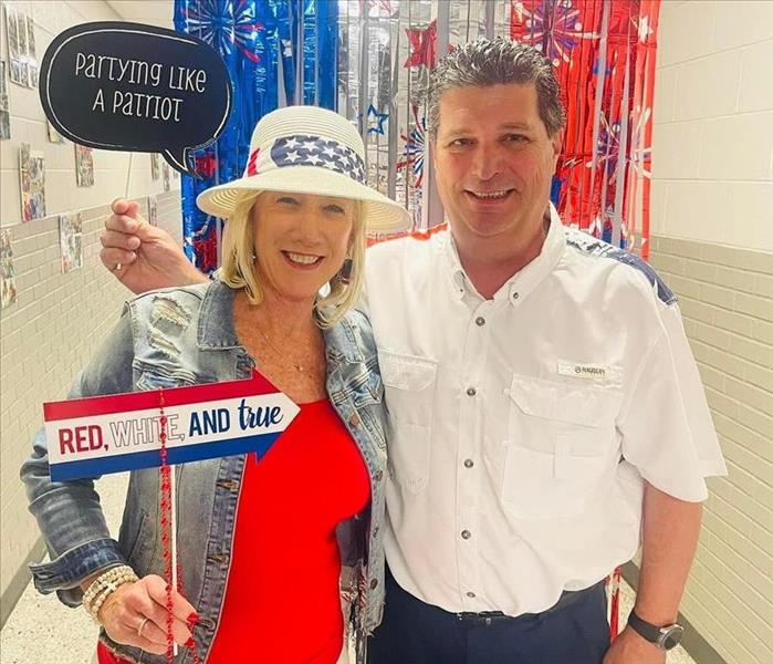 Owners Mel and Kimberly Kitchens being patriotic in Red -White and Blue