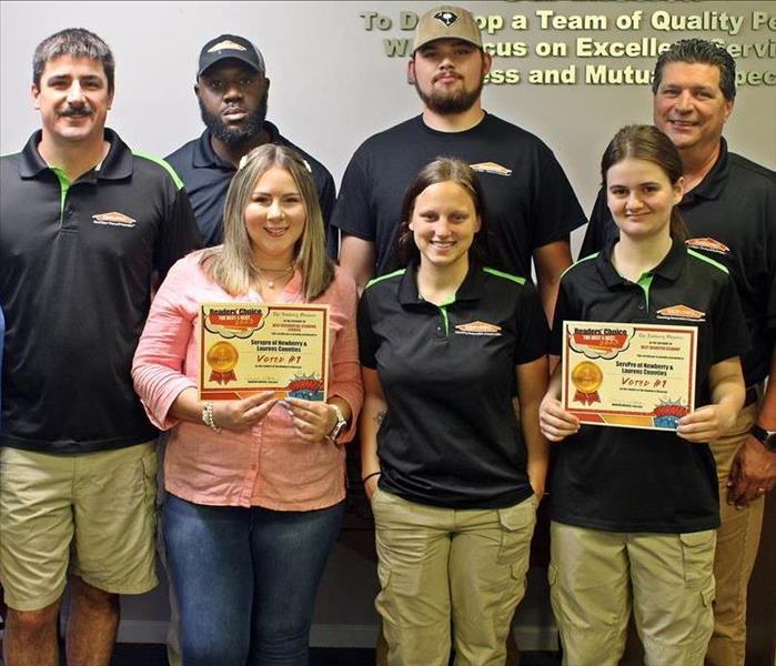 SERVPRO team accepting their awards from the Newberry Observer