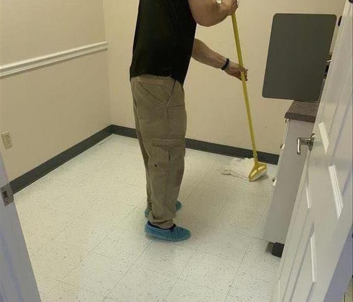 SERVPRO technician cleaning the floors in an office in Clinton, SC