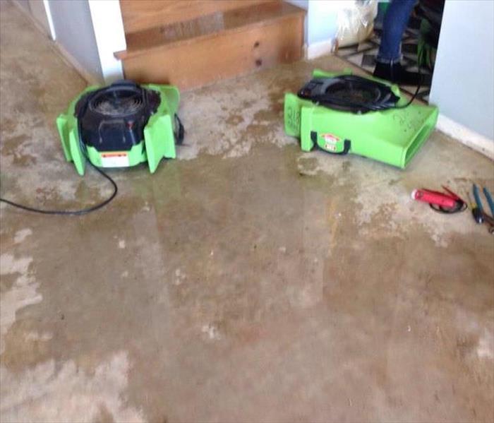 SERVPRO dryers working hard to remove the water damage caused from a busted water line from the water heater in their home. 