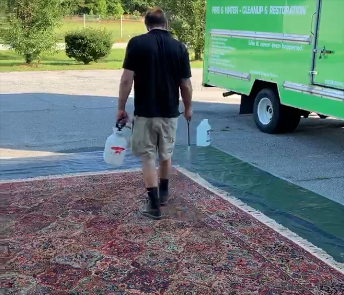 SERVPRO Technican treating an area rug to be cleaned at our facility in Newberry, SC 