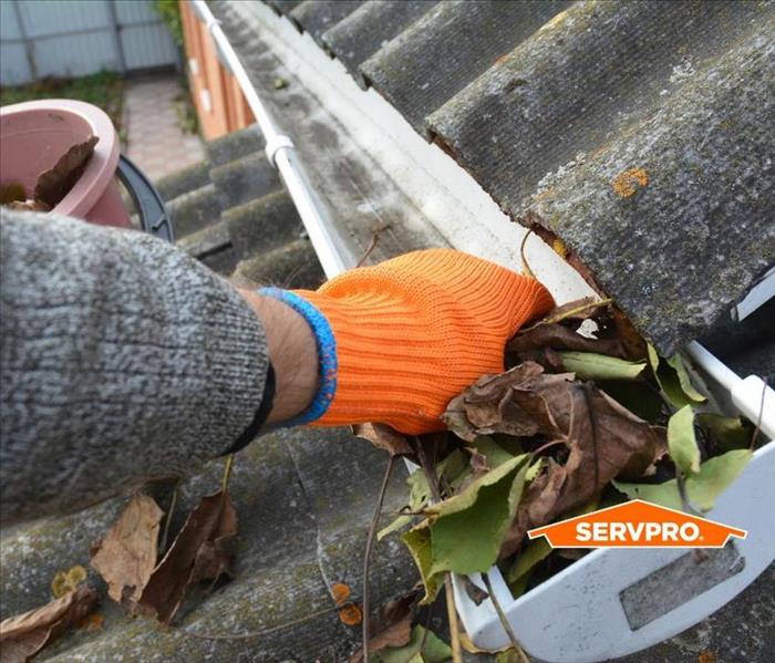 Cleaning out debris in a gutter 